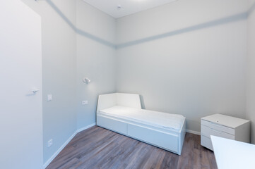 Minimalist Modern Home Bedroom Interior with White Furniture and Wooden Floors