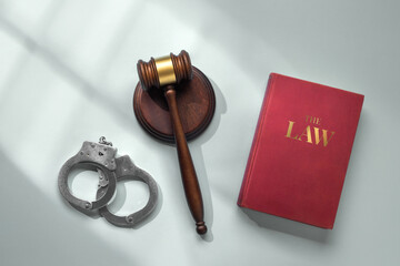 Judge's gavel with sound block, handcuffs and 