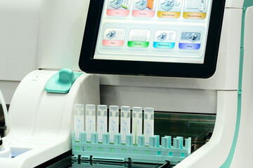 The computer monitor displays a menu of medical device options. The device is used to diagnose various diseases and conditions.