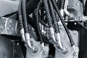 Hydraulic power drive hoses of high pressure machine, industrial power concept background.