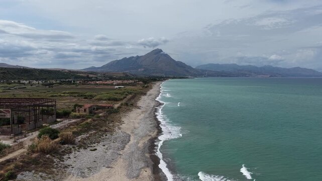 Aerial drone view of Campofelice di Roccella, a charming Sicilian seaside village in northern Sicily, Italy, showing traditional holiday homes, coastline, and panoramic Tyrrhenian Sea vistas