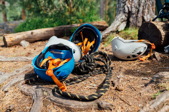 Close-Up of Climbing Helmets and Rope on Forest Ground
