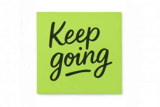 Lime green sticky note with keep going text, symbolizing motivation, perseverance, and encouraging positive thinking
