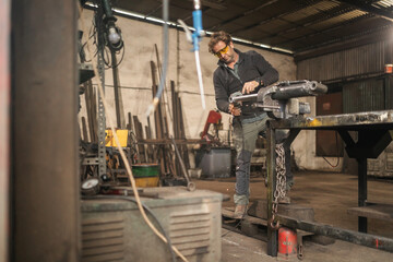 Blacksmith working in workshop