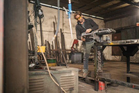 Blacksmith working in workshop