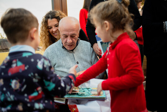 Children Celebrate With Elderly Man During a Special Gathering