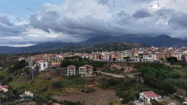 Aerial drone view of Campofelice di Roccella, a historic Sicilian village in Palermo,Sicily, Italy, featuring traditional stone houses, the Madonie Mountains, and the iconic highway viaduct