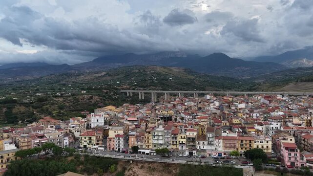 Aerial drone view of Campofelice di Roccella, a historic Sicilian village in Palermo,Sicily, Italy, featuring traditional stone houses, the Madonie Mountains, and the iconic highway viaduct