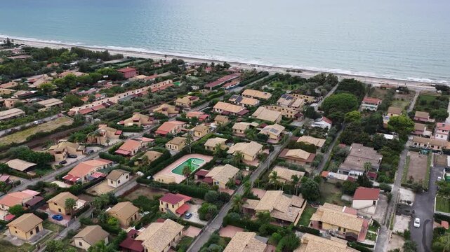 Aerial drone view of Campofelice di Roccella, a charming Sicilian seaside village in northern Sicily, Italy, showing traditional holiday homes, coastline, and panoramic Tyrrhenian Sea vistas
