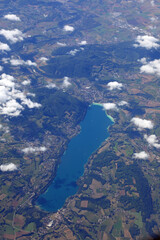 high angle view of a lake in the middle of the flat land and the white clouds © ChiccoDodiFC