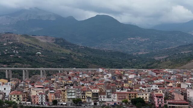 Aerial drone view of Campofelice di Roccella, a historic Sicilian village in Palermo,Sicily, Italy, featuring traditional stone houses, the Madonie Mountains, and the iconic highway viaduct