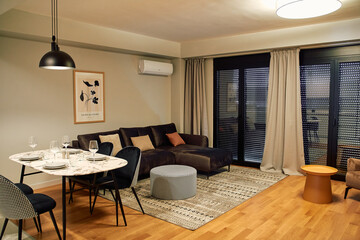 A Modern and Cozy Living Space Featuring a Comfortable Sofa, Elegant Dining Area, and Stylish Decor, Perfect for Relaxation and Entertaining Guests