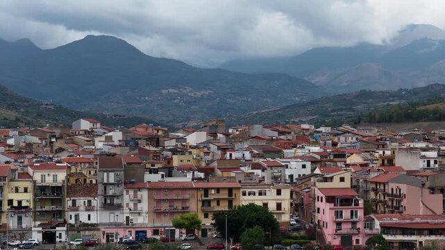 Aerial drone view of Campofelice di Roccella, a historic Sicilian village in Palermo,Sicily, Italy, featuring traditional stone houses, the Madonie Mountains, and the iconic highway viaduct