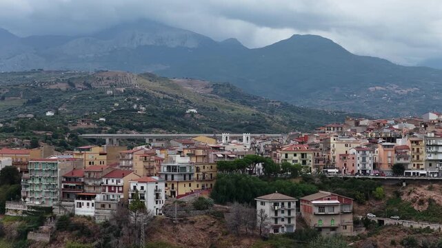 Aerial drone view of Campofelice di Roccella, a historic Sicilian village in Palermo,Sicily, Italy, featuring traditional stone houses, the Madonie Mountains, and the iconic highway viaduct
