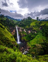 Obraz premium Lush landscape with cascading waterfall