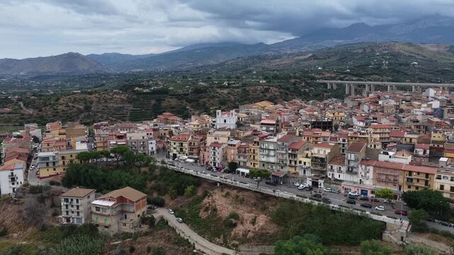 Aerial drone view of Campofelice di Roccella, a historic Sicilian village in Palermo,Sicily, Italy, featuring traditional stone houses, the Madonie Mountains, and the iconic highway viaduct