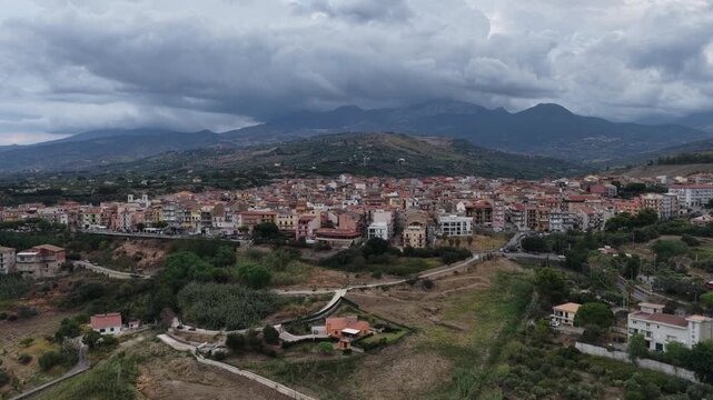 Aerial drone view of Campofelice di Roccella, a historic Sicilian village in Palermo,Sicily, Italy, featuring traditional stone houses, the Madonie Mountains, and the iconic highway viaduct