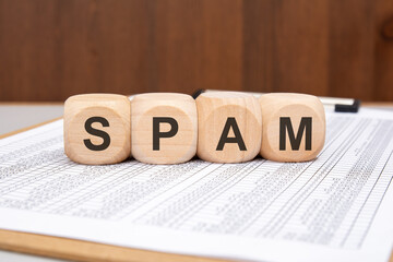 Wooden blocks with SPAM word on spreadsheet document background