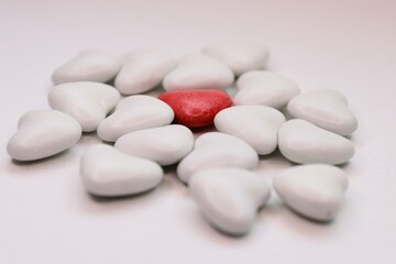 A red heart among white ones — a conceptual photo about love, uniqueness, and the power of emotions. Perfect for Valentine's Day designs, social campaigns, psychological themes, branding.