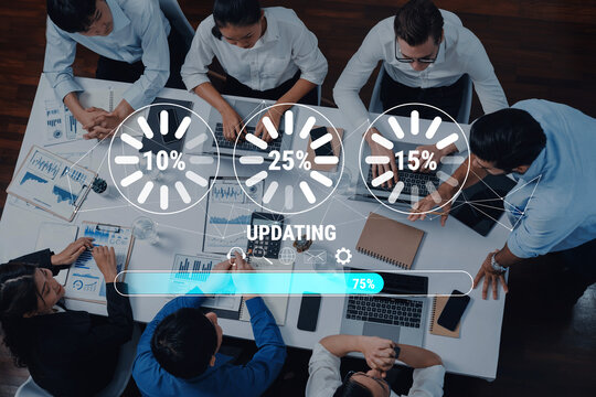 A top-down view of a diverse team collaborating in a modern office setting with visual progress indicators showing project updates, enhancing productivity and creativity. Trope