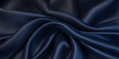 Obraz premium Close-up of Draped blue Satin Fabric. A close-up view of luxurious black satin fabric with dramatic folds and drapes. 