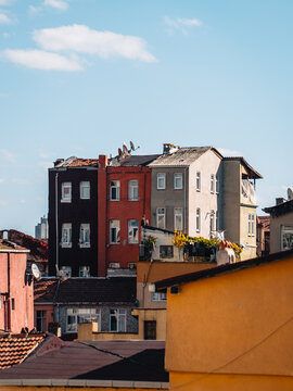 View of vibrant buildings stacked together in a residential area, creating a patchwork of colors against the clear blue sky, Istanbul, &Auml;&deg;stanbul, T&Atilde;&frac14;rkiye.