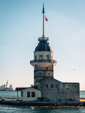 View of the historic Maiden's Tower standing proudly against the azure sky, with a ship sailing in the distance, Istanbul, &Auml;&deg;stanbul, T&Atilde;&frac14;rkiye.