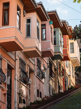 View of colorful, vintage houses with bay windows cascade down a sloped street, their facades a mix of pastel hues and architectural details, Istanbul, &Auml;&deg;stanbul, T&Atilde;&frac14;rkiye.