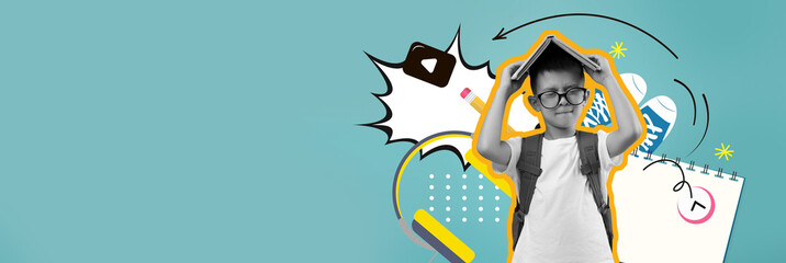 A young boy with glasses stands confidently while holding a triangular cardboard piece above his head. The background features vibrant patterns and playful designs, creating an energetic atmosphere.