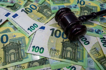 Judge gavel on euro bills, law, justice, corruption and financial crime business concept