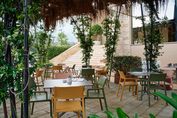 Inviting Outdoor Dining Area Featuring Colorful Chairs and Tables Surrounded by Lush Greenery in a Cozy Ambiance Perfect for Relaxation