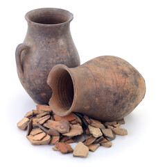 Ancient clay pots and broken pottery shards isolated on white background