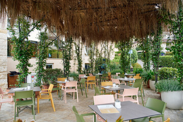 Charming Outdoor Dining Area Surrounded by Lush Greenery and Rustic Decor Perfect for Relaxing Meals and Social Gatherings in a Tranquil Setting