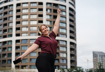 Fototapeta premium Body positive woman warming up before training.
