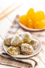 Japanese mochi dessert on plate on checkered napkin.