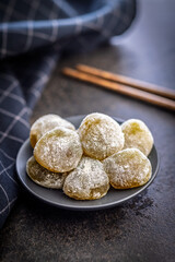 Japanese mochi dessert on plate on black table.