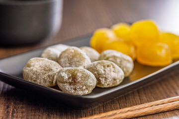 Japanese mochi dessert on plate on wooden table.