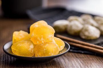 Japanese mochi dessert on plate on checkered napkin.
