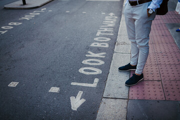 Businessman wearing wristwatch and formal clothes in city.