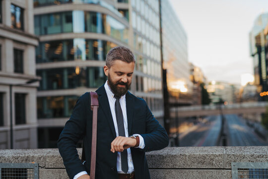 Businessman checking time on his watch.