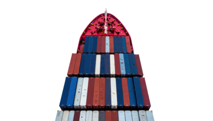 Overhead view of a cargo ship's bow loaded with stacks of colorful shipping containers