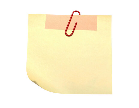 A yellow paper note, affixed with a red paperclip and tape, on a black background