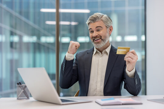 Happy senior businessman celebrating online shopping success