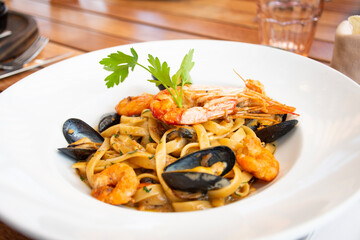 pasta dish al mare seafood with shrimp and shellfish in bistro close-up
