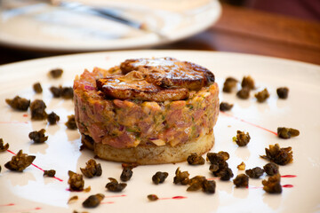 Beef tartare with mushrooms and capers in bistro restaurant