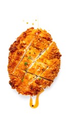Crispy, golden-brown breaded chicken breast, sliced, drizzled with sauce, isolated on white