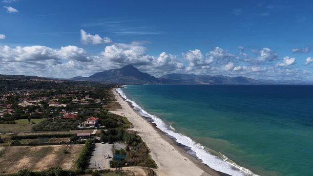 Aerial drone view of Campofelice di Roccella, a charming Sicilian seaside village in northern Sicily, Italy, showing traditional holiday homes, coastline, and panoramic Tyrrhenian Sea vistas