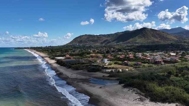 Aerial drone view of Campofelice di Roccella, a charming Sicilian seaside village in northern Sicily, Italy, showing traditional holiday homes, coastline, and panoramic Tyrrhenian Sea vistas