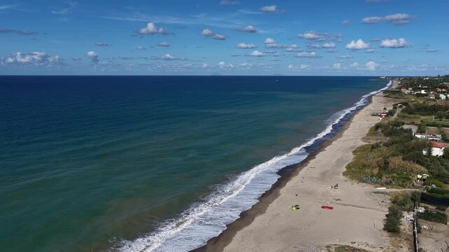Aerial drone view of Campofelice di Roccella, a charming Sicilian seaside village in northern Sicily, Italy, showing traditional holiday homes, coastline, and panoramic Tyrrhenian Sea vistas