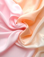 Soft, flowing fabric in a gradient of blush pink to peach